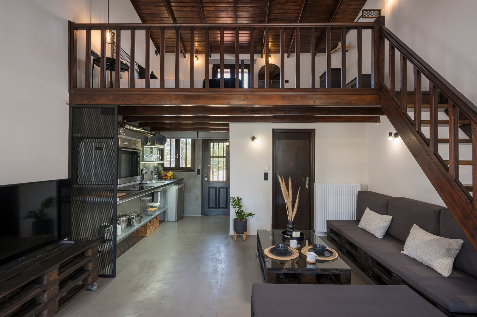 Living room with the wooden stairs to the bedroom
